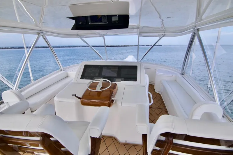 Serenity Now Yacht Photos Pics 2014 Viking 66 Convertible yacht helm with ocean view, featuring luxurious white seating and wood accents.