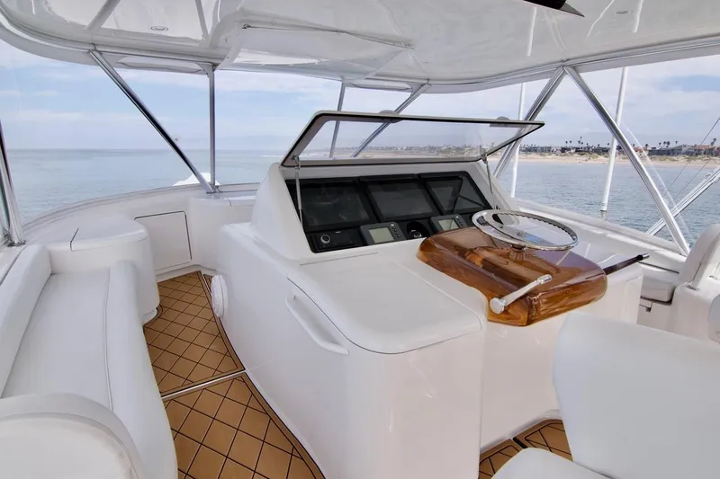 Serenity Now Yacht Photos Pics Luxurious helm of 2014 Viking 66 Convertible yacht with modern controls and ocean view.