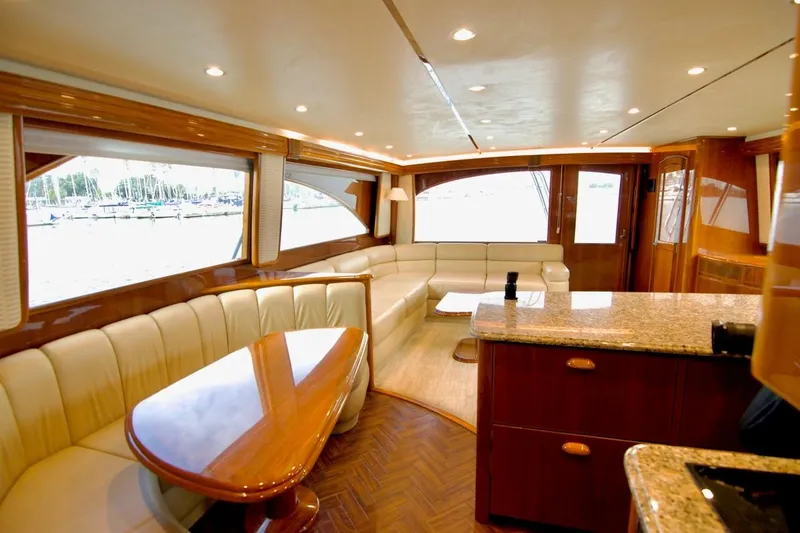 Serenity Now Yacht Photos Pics Luxurious interior of 2014 Viking 66 Convertible yacht with elegant seating and wooden finishes.
