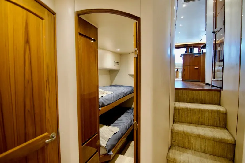 Serenity Now Yacht Photos Pics Interior of 2014 Viking 66 Convertible yacht with wooden doors and bunk beds.