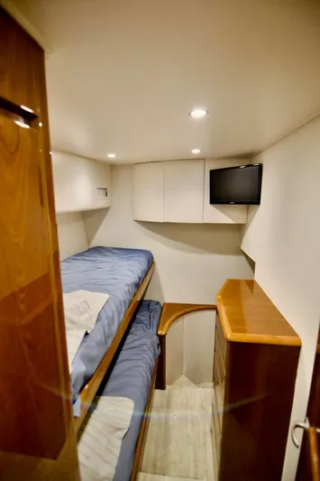 Serenity Now Yacht Photos Pics Interior of 2014 Viking 66 Convertible yacht with bunk beds and TV.