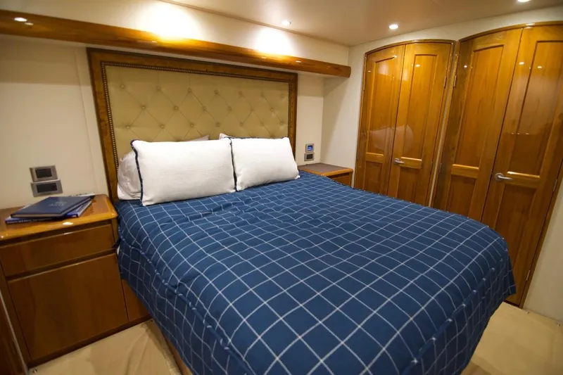 Serenity Now Yacht Photos Pics Luxurious bedroom in 2014 Viking 66 Convertible yacht with blue checkered bedding.