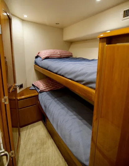 Serenity Now Yacht Photos Pics Bunk beds in 2014 Viking 66 Convertible yacht cabin with wooden interior.