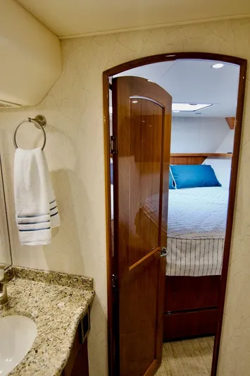 Serenity Now Yacht Photos Pics Interior of 2014 Viking 66 Convertible yacht showing bedroom and bathroom.