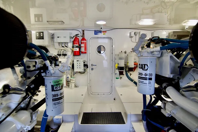 Serenity Now Yacht Photos Pics Engine room of 2014 Viking 66 Convertible yacht, featuring CAT machinery and safety equipment.