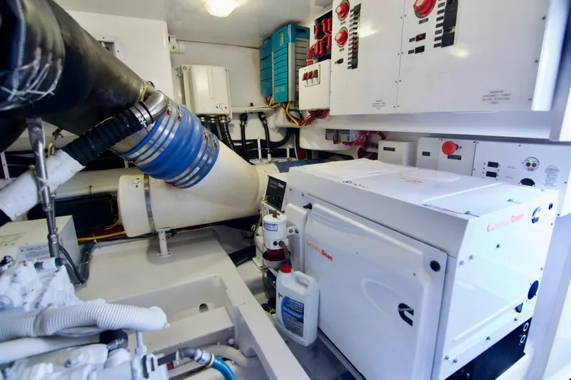 Serenity Now Yacht Photos Pics Engine room of 2014 Viking 66 Convertible yacht with Cummins generator and control panels.