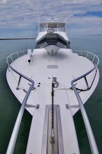 Serenity Now Yacht Photos Pics 2014 Viking 66 Convertible yacht on calm water under a cloudy sky.