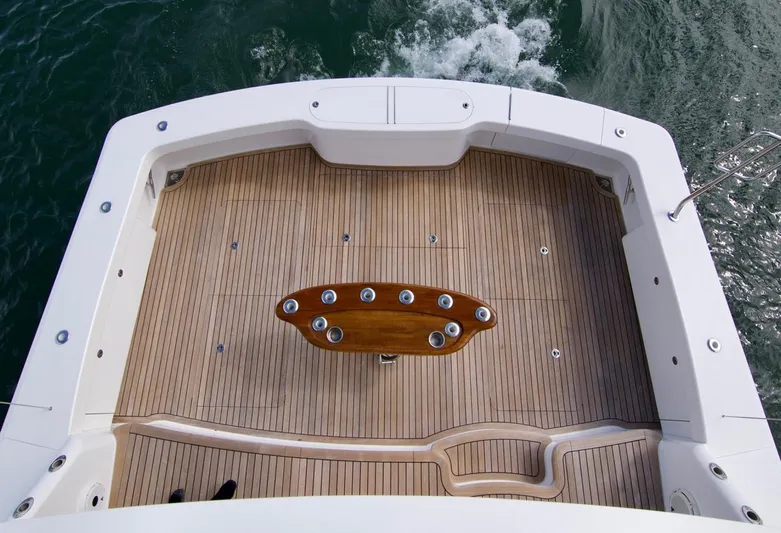 Serenity Now Yacht Photos Pics Viking 66 Convertible 2014 yacht deck with wooden flooring and central table.