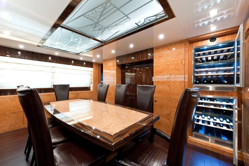  Yacht Photos Pics Luxurious dining area on 2009 Maiora 32 yacht with elegant table and wine storage.