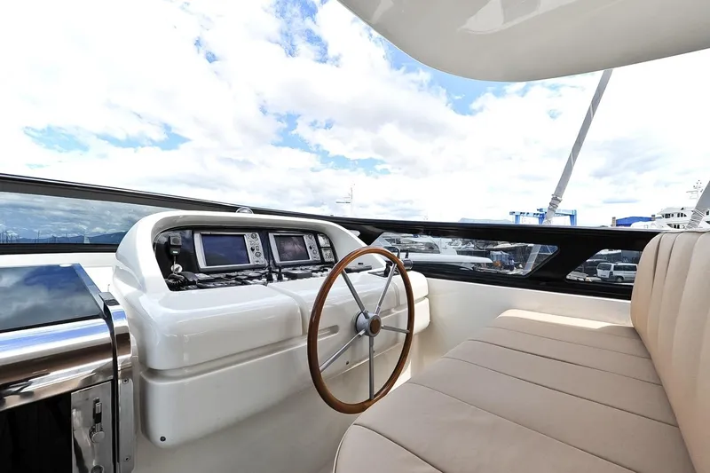 Yacht Photos Pics Helm of 2009 Maiora 32 yacht with modern navigation equipment and beige seating.