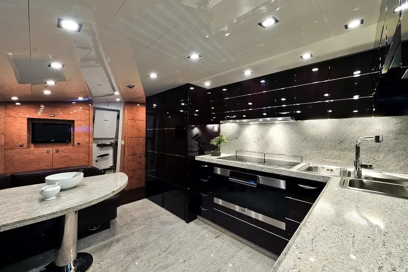  Yacht Photos Pics Luxurious kitchen interior of 2009 Maiora 32 yacht with modern appliances and sleek design.