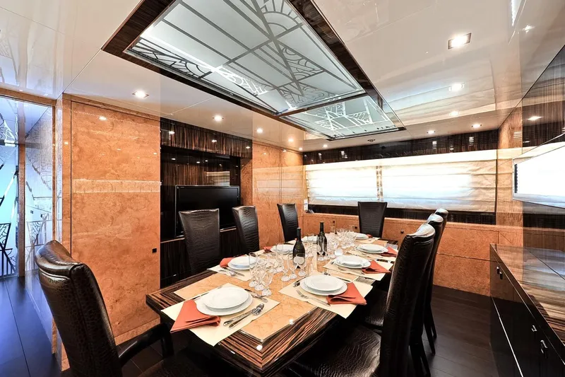  Yacht Photos Pics Luxurious dining area on 2009 Maiora 32 yacht, featuring elegant table settings and modern decor.