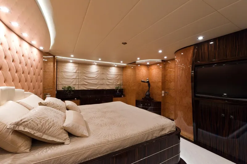  Yacht Photos Pics Luxurious bedroom interior on 2009 Maiora 32 yacht, featuring elegant decor and ambient lighting.