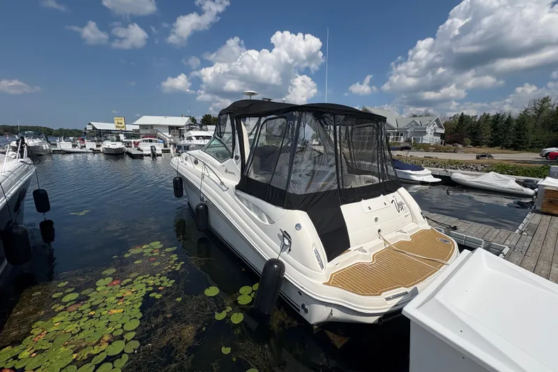  Yacht Photos Pics 2005 Sea Ray 340 Sundancer docked at marina under blue sky.