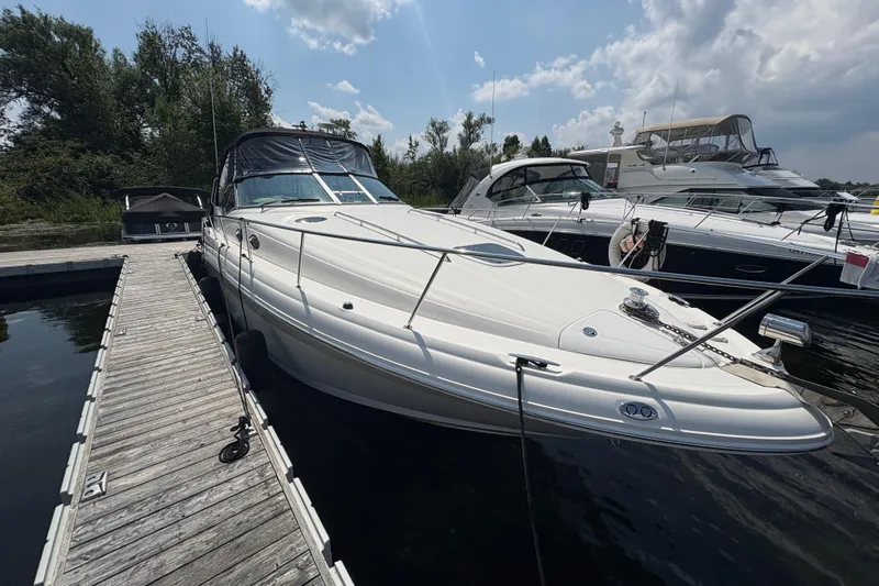  Yacht Photos Pics 2005 Sea Ray 340 Sundancer docked at marina under cloudy sky.