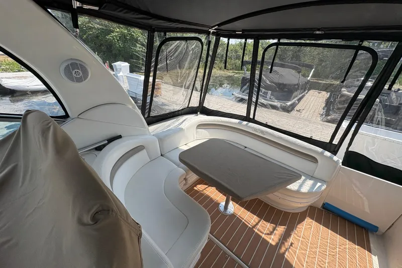  Yacht Photos Pics Interior of 2005 Sea Ray 340 Sundancer yacht with seating and table, docked outdoors.