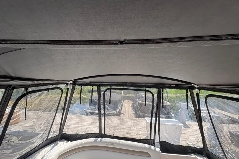  Yacht Photos Pics 2005 Sea Ray 340 Sundancer interior with clear canopy and dock view.