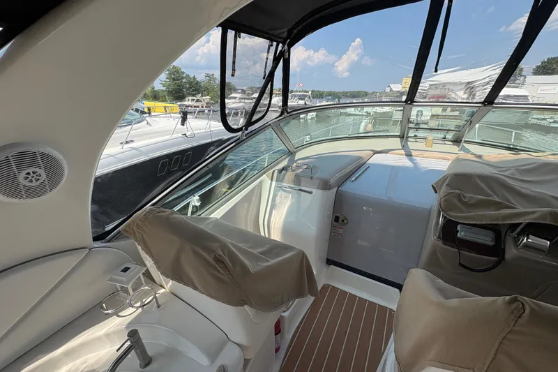 Yacht Photos Pics 2005 Sea Ray 340 Sundancer cockpit with covered seats and marina view.