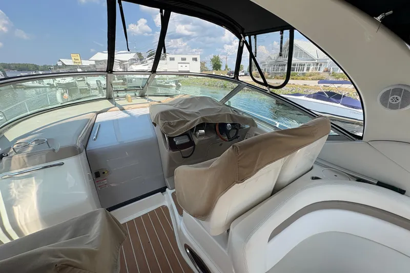  Yacht Photos Pics 2005 Sea Ray 340 Sundancer cockpit with covered seats, docked at marina.