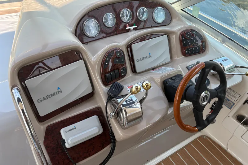  Yacht Photos Pics Cockpit of 2005 Sea Ray 340 Sundancer with Garmin navigation system and wood-accented steering wheel.
