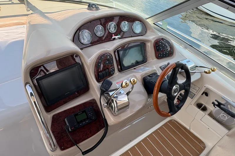  Yacht Photos Pics 2005 Sea Ray 340 Sundancer helm with navigation instruments and wooden steering wheel.