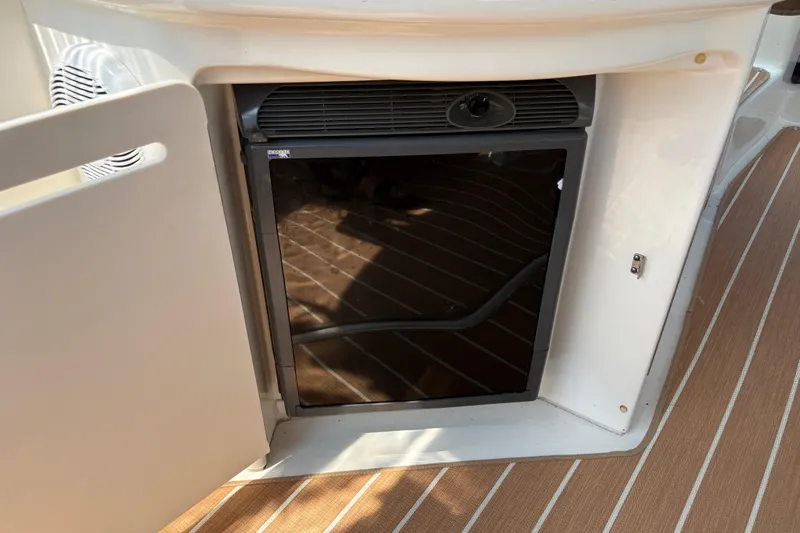  Yacht Photos Pics Open mini fridge on 2005 Sea Ray 340 Sundancer boat with wood-patterned flooring.