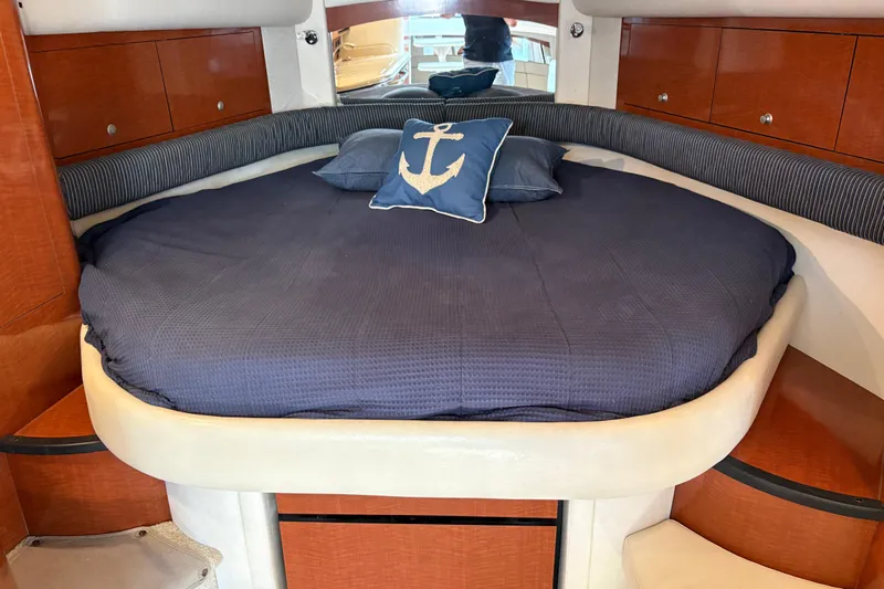  Yacht Photos Pics 2005 Sea Ray 340 Sundancer cabin with blue bedding and anchor pillow.