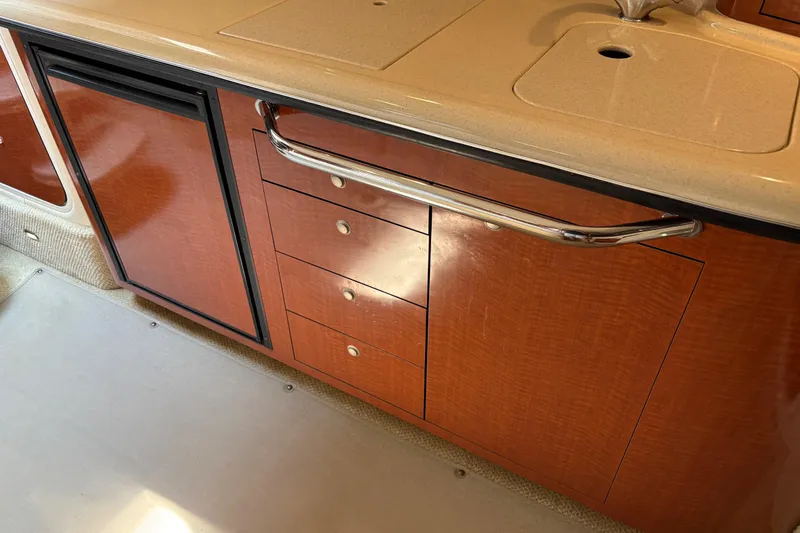  Yacht Photos Pics 2005 Sea Ray 340 Sundancer interior with wooden cabinetry and sink.