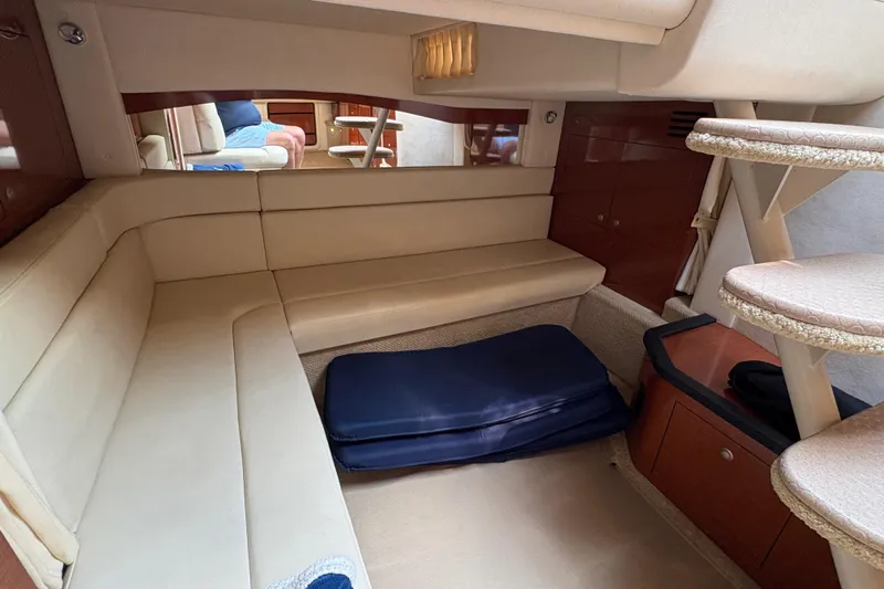  Yacht Photos Pics Interior of 2005 Sea Ray 340 Sundancer with beige seating and compact design.