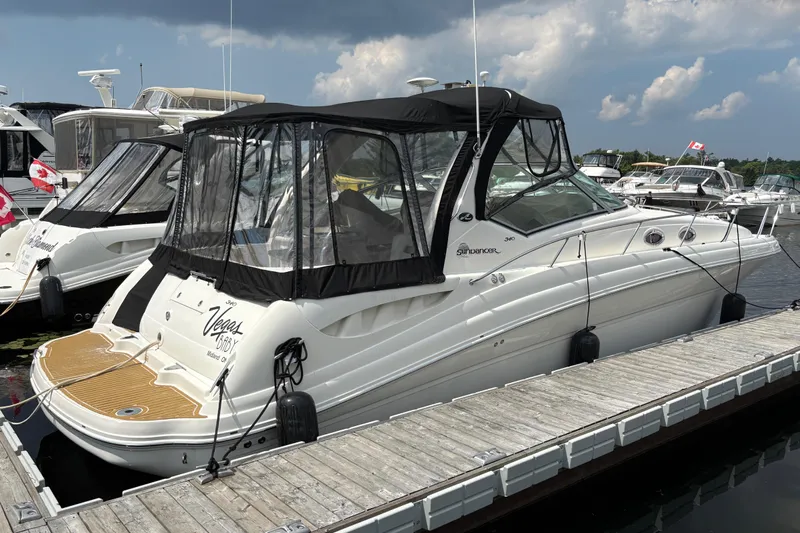  Yacht Photos Pics 2005 Sea Ray 340 Sundancer docked at marina under cloudy sky.