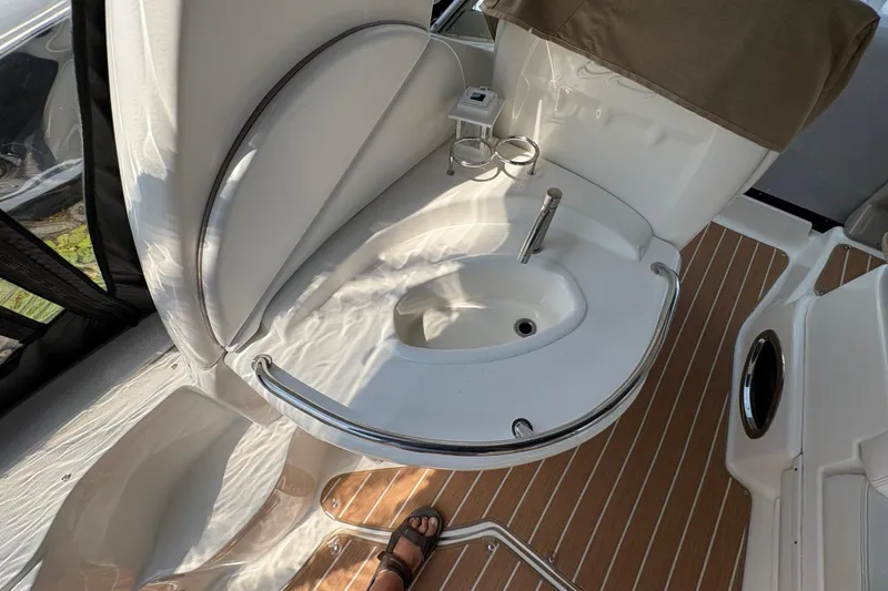  Yacht Photos Pics 2005 Sea Ray 340 Sundancer boat interior with sink and wooden flooring.