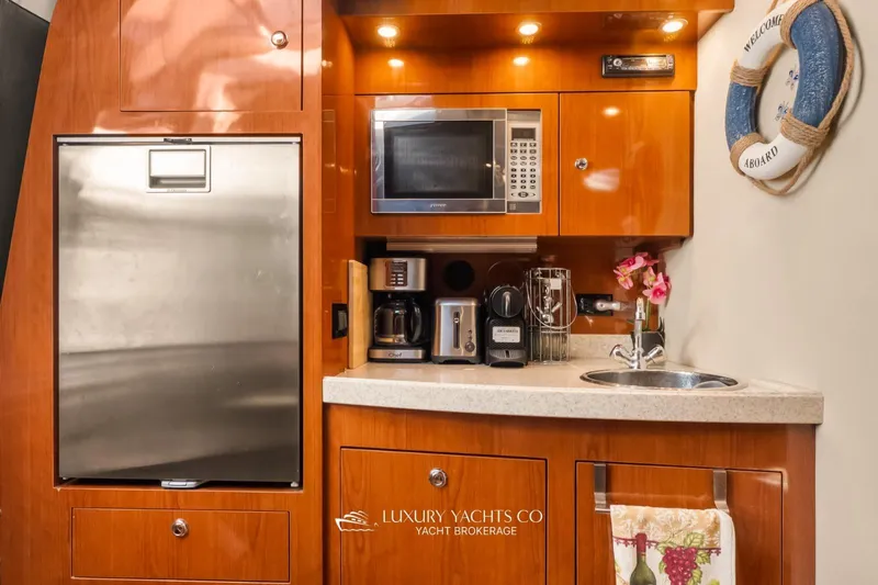  Yacht Photos Pics Luxurious 2007 Regal Commodore 3760 IB yacht kitchen with modern appliances and elegant wood finish.