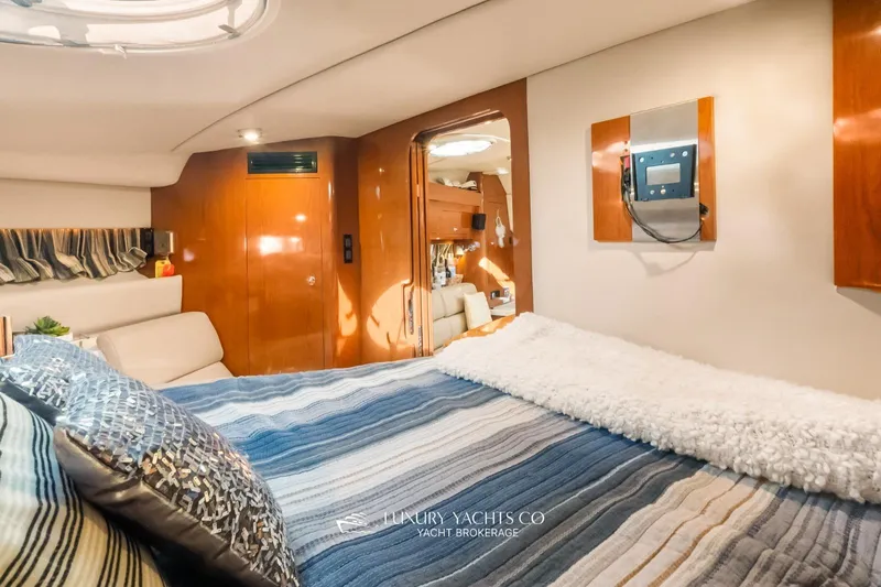  Yacht Photos Pics Luxurious interior of 2007 Regal Commodore 3760 IB yacht with cozy bedding and elegant wood finishes.