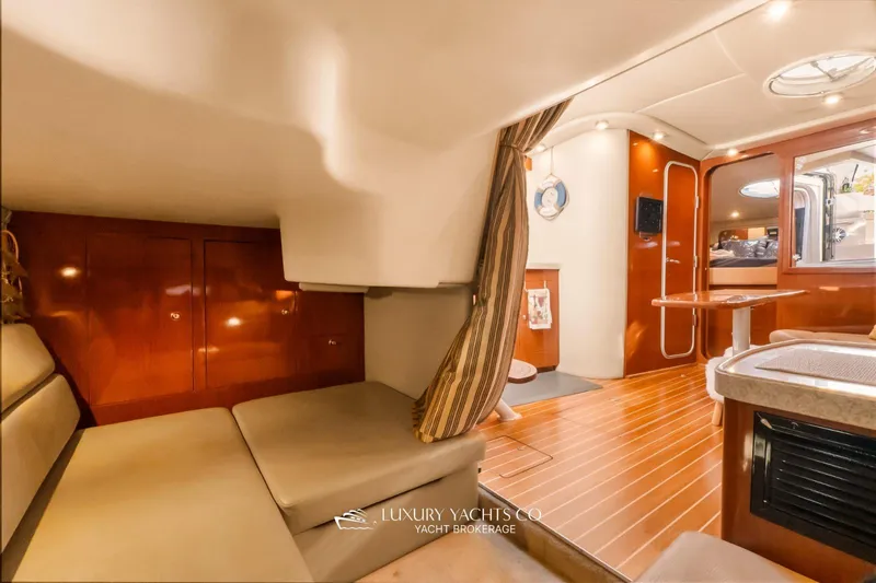  Yacht Photos Pics 2007 Regal Commodore 3760 IB yacht interior with wood finishes and cozy seating area.