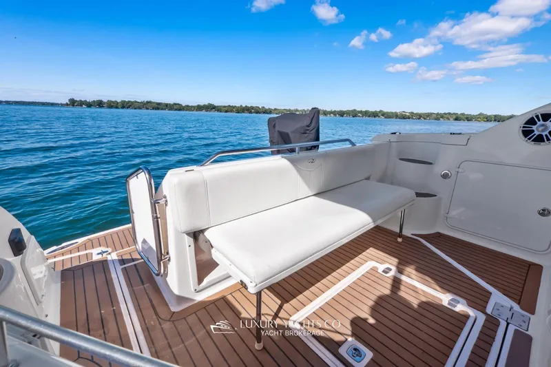  Yacht Photos Pics 2007 Regal Commodore 3760 IB yacht deck with seating, overlooking serene blue waters.