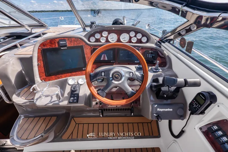  Yacht Photos Pics Helm of 2007 Regal Commodore 3760 IB yacht with wood accents and modern controls.