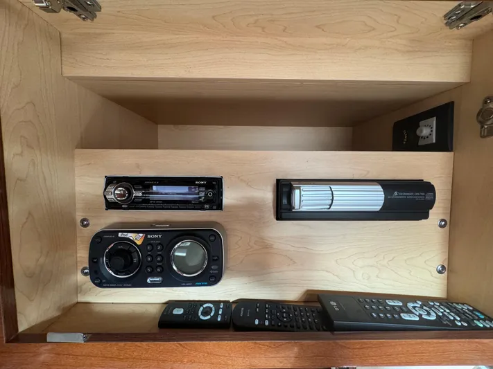 Pendragon Yacht Photos Pics Cabinet with audio system and remotes in 2009 Sea Ray 350 Sundancer boat.