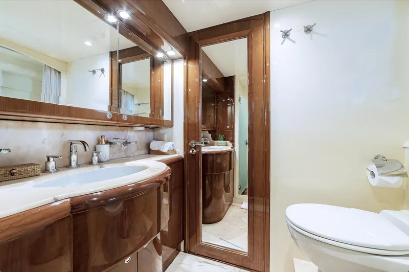 Theion Yacht Photos Pics Luxurious bathroom on 1997 Baglietto 31m yacht with elegant wood finishes and modern fixtures.