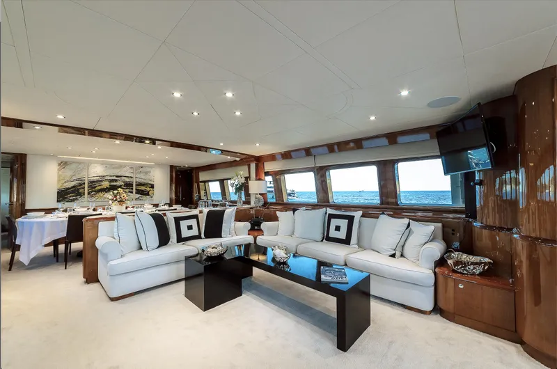 Theion Yacht Photos Pics Luxurious interior of 1997 Baglietto 31m yacht with elegant seating and panoramic windows.