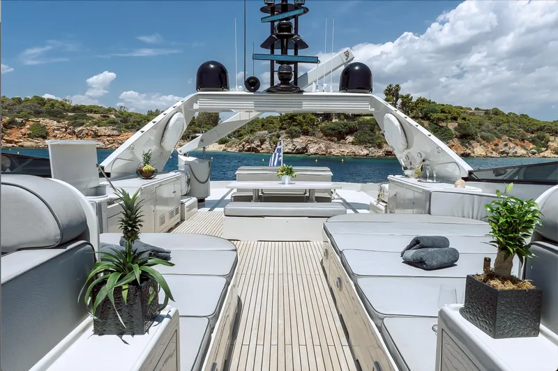 Theion Yacht Photos Pics Luxurious 1997 Baglietto 31m yacht deck with elegant seating and scenic ocean view.