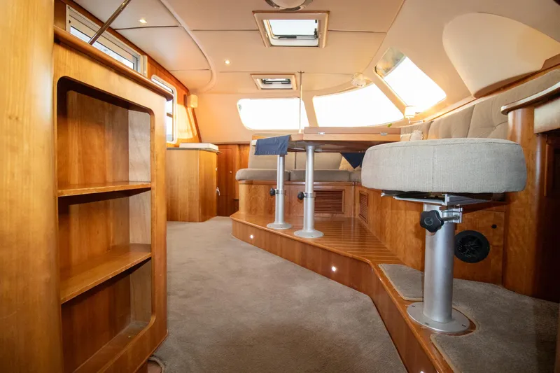 Amazing Grace Yacht Photos Pics Luxurious interior of 2004 Antares PDQ 44 yacht with wooden finishes and plush seating.