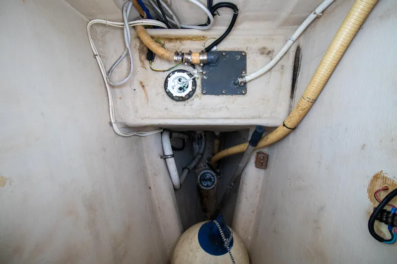 Amazing Grace Yacht Photos Pics Engine compartment of a 2004 Antares PDQ 44 boat, showing hoses and mechanical components.