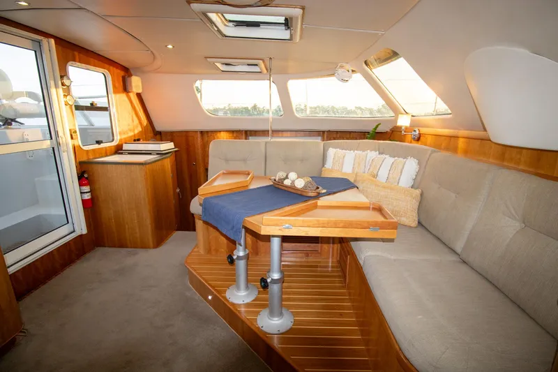 Amazing Grace Yacht Photos Pics Luxurious interior of 2004 Antares PDQ 44 yacht with elegant seating and wooden accents.