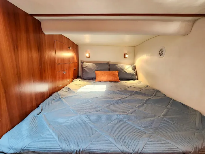 Amazing Grace Yacht Photos Pics Cozy cabin bedroom in 2004 Antares PDQ 44 yacht with wood paneling and blue bedding.