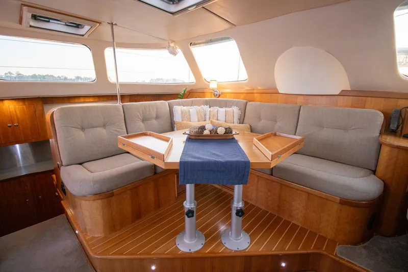 Amazing Grace Yacht Photos Pics Luxurious interior of 2004 Antares PDQ 44 yacht with elegant seating and wooden accents.