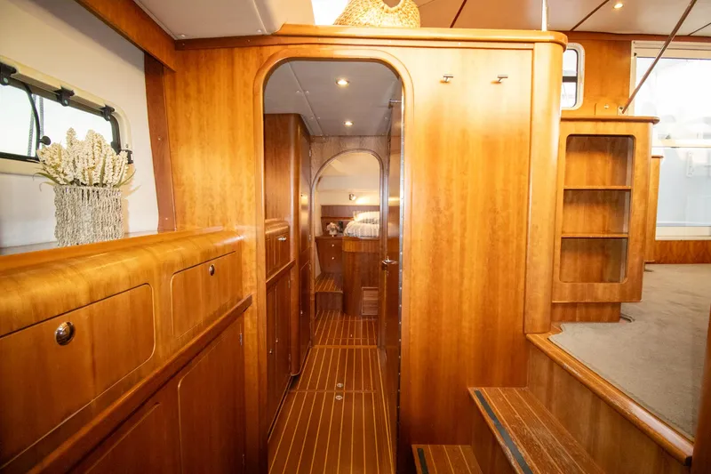 Amazing Grace Yacht Photos Pics Luxurious wooden interior of 2004 Antares PDQ 44 yacht, featuring elegant cabinetry and cozy ambiance.