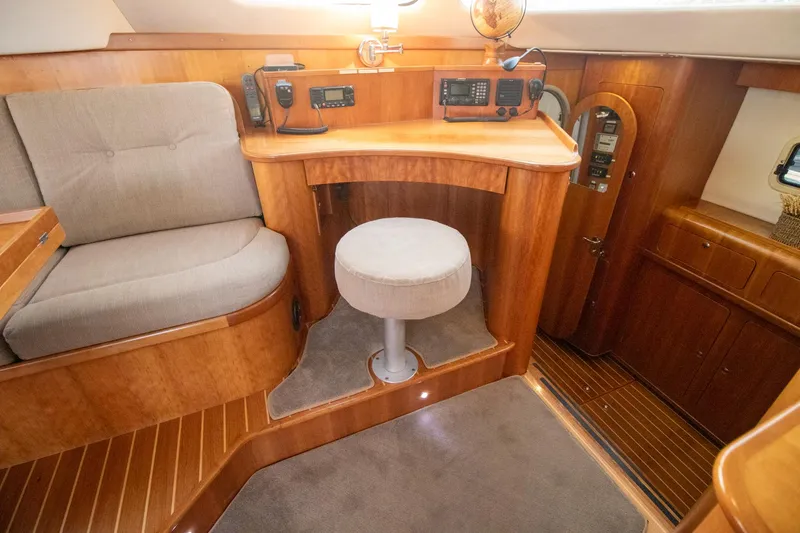 Amazing Grace Yacht Photos Pics Luxurious 2004 Antares PDQ 44 yacht interior with wood finish and navigation equipment.