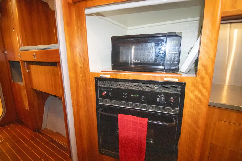 Amazing Grace Yacht Photos Pics Galley of 2004 Antares PDQ 44 with microwave and oven, featuring wood cabinetry.
