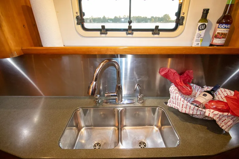 Amazing Grace Yacht Photos Pics Modern kitchen sink area on 2004 Antares PDQ 44 yacht with window view.
