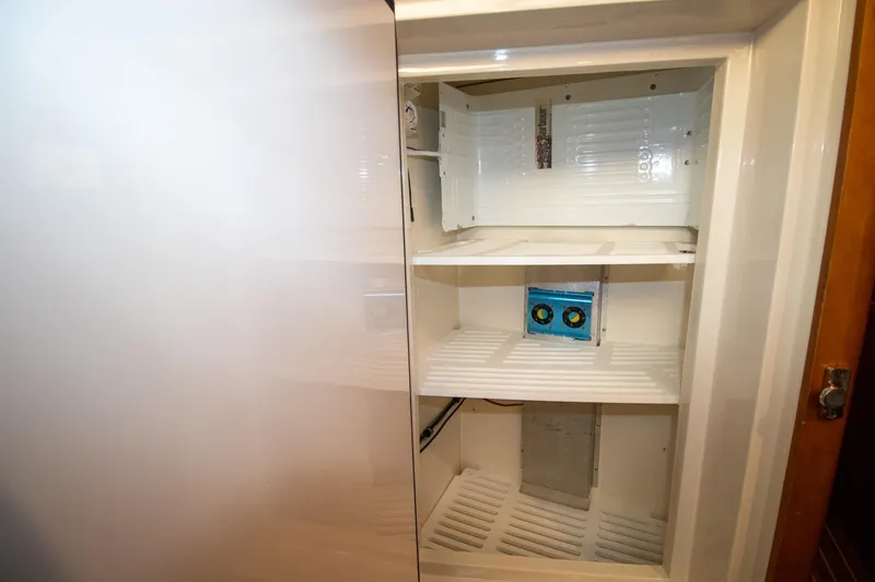 Amazing Grace Yacht Photos Pics Empty refrigerator interior on Antares PDQ 44, 2004 model, with visible shelves and compartments.